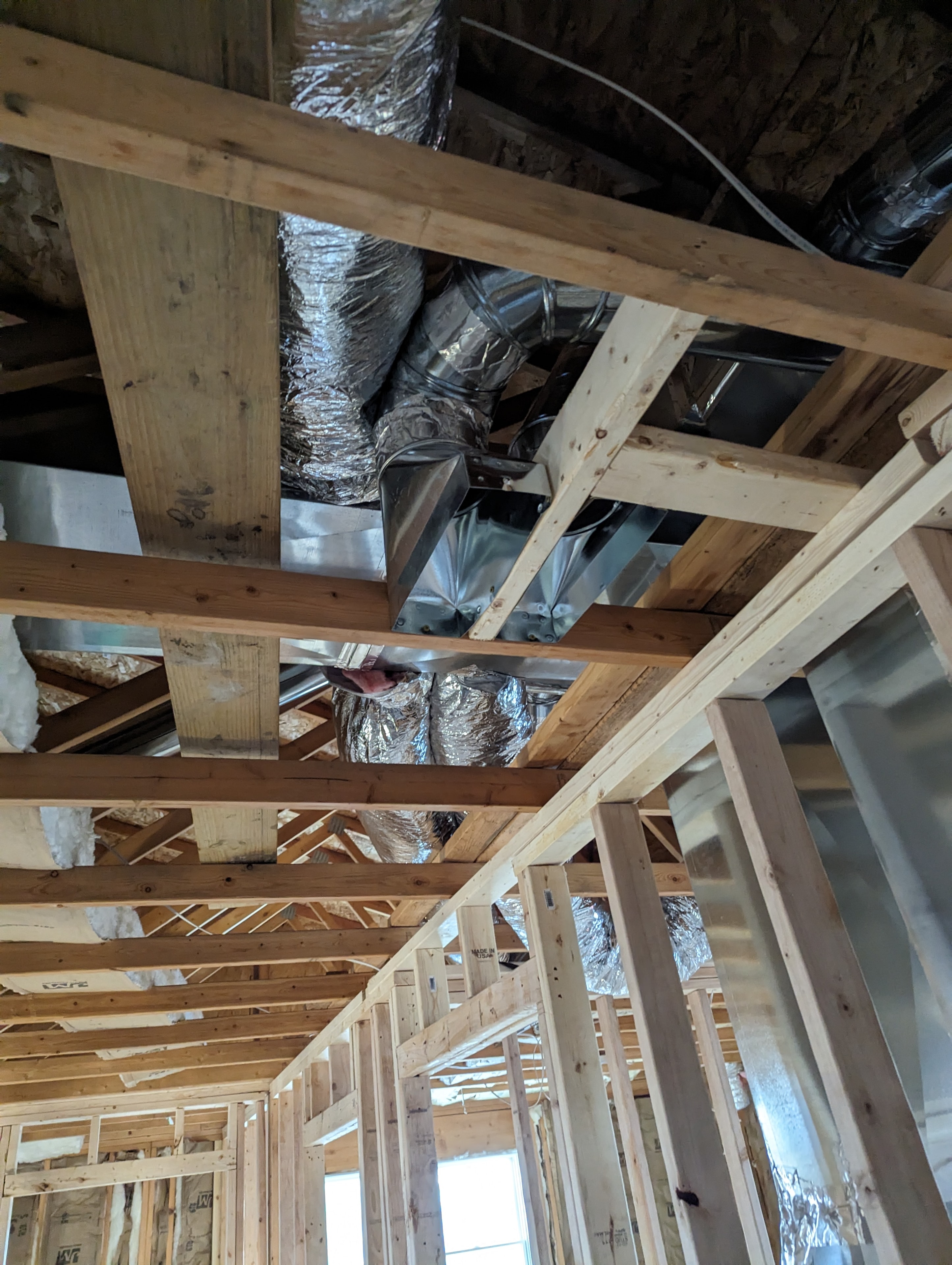 Flexible duct routing through framing