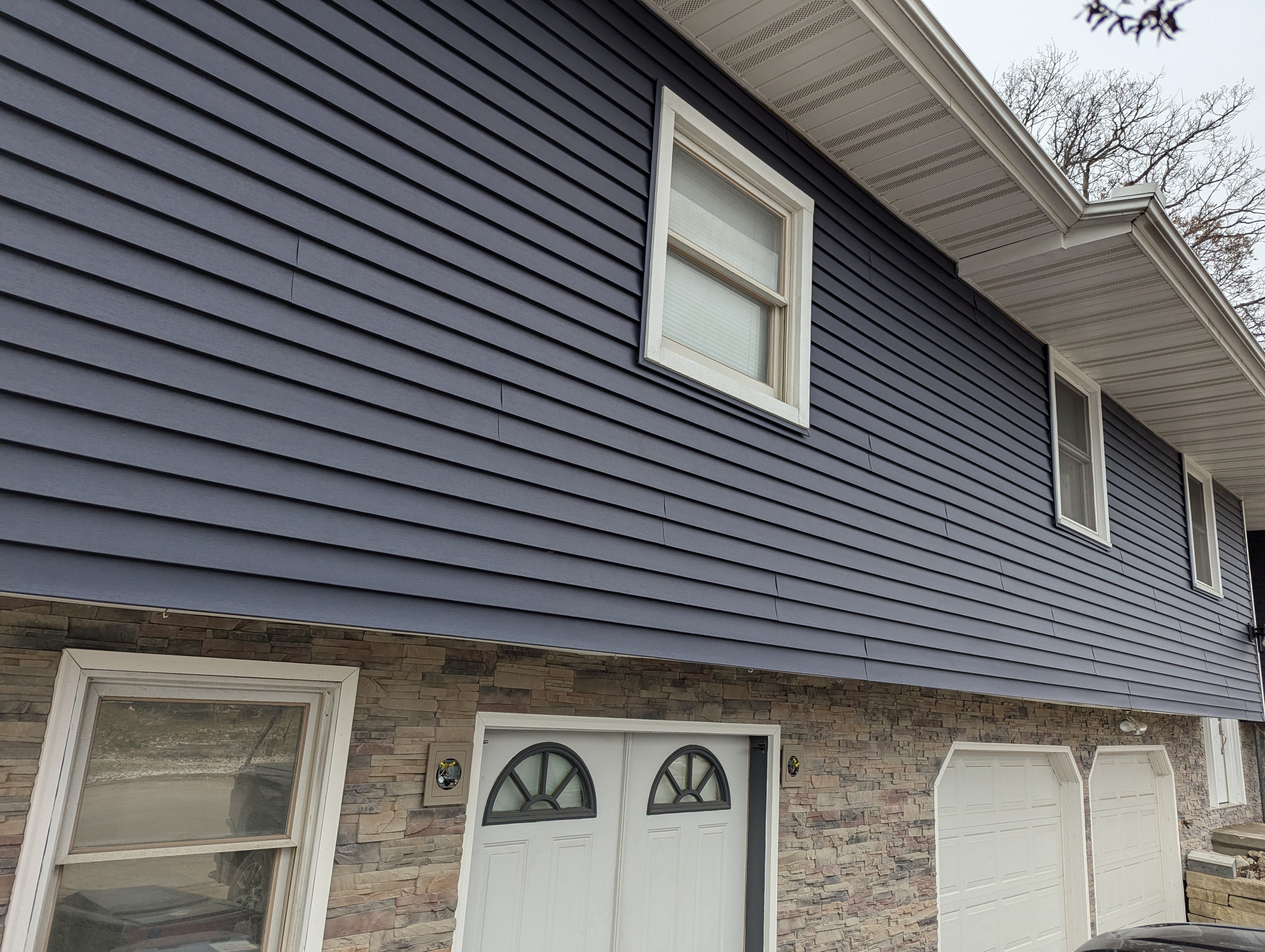 Exterior siding — navy blue with stone