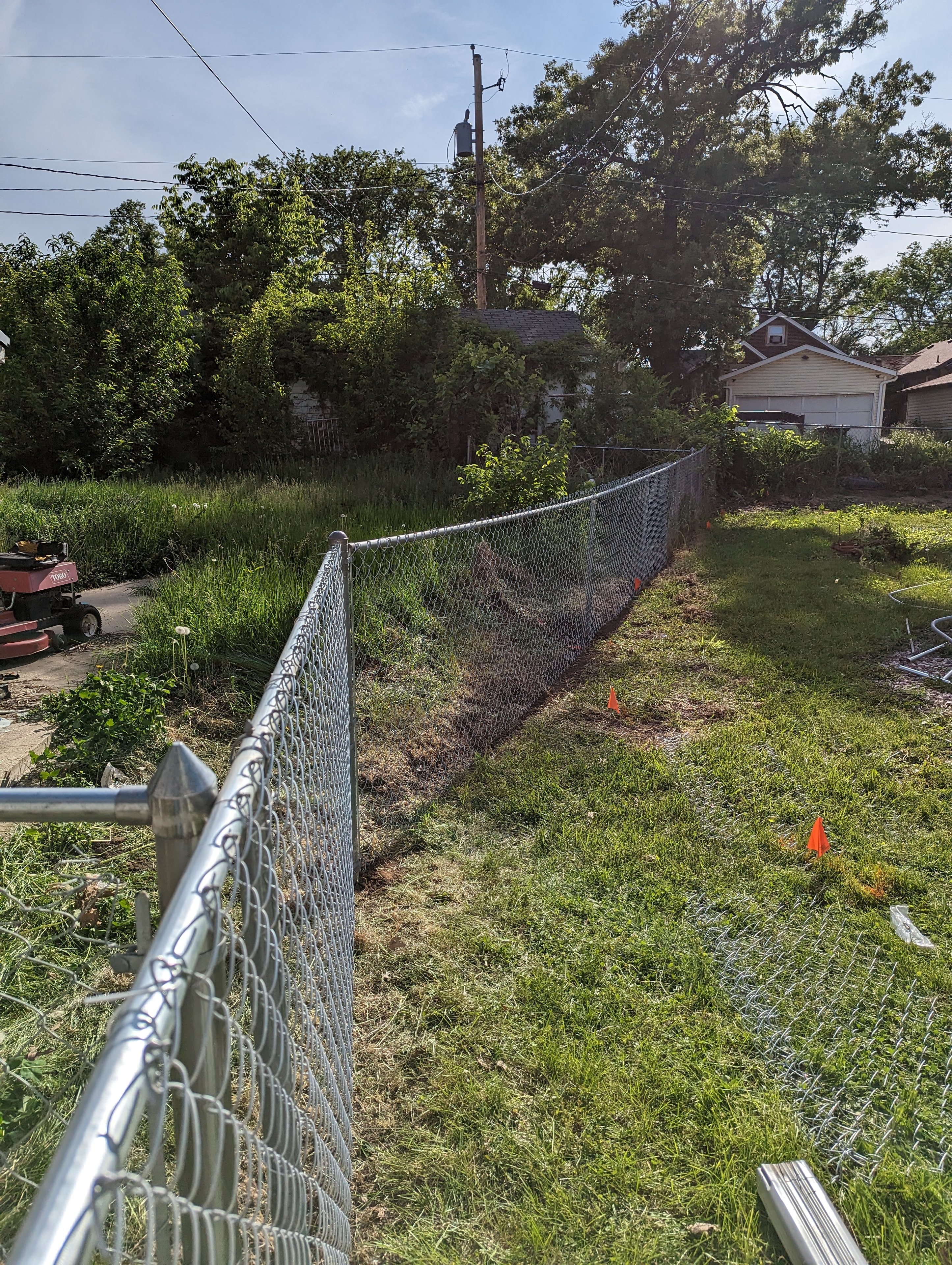 Chain-link fence run with layout markers