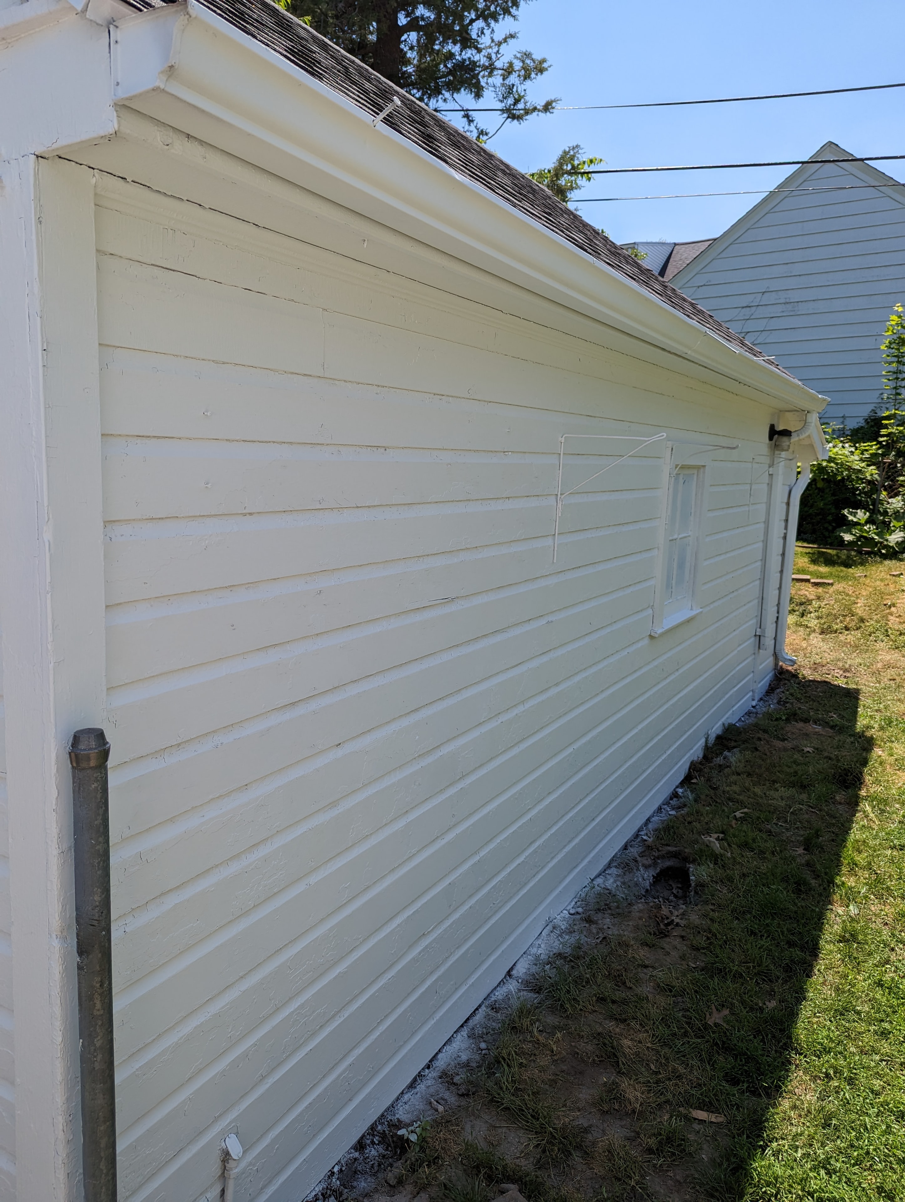 Garage siding — freshly painted white lap