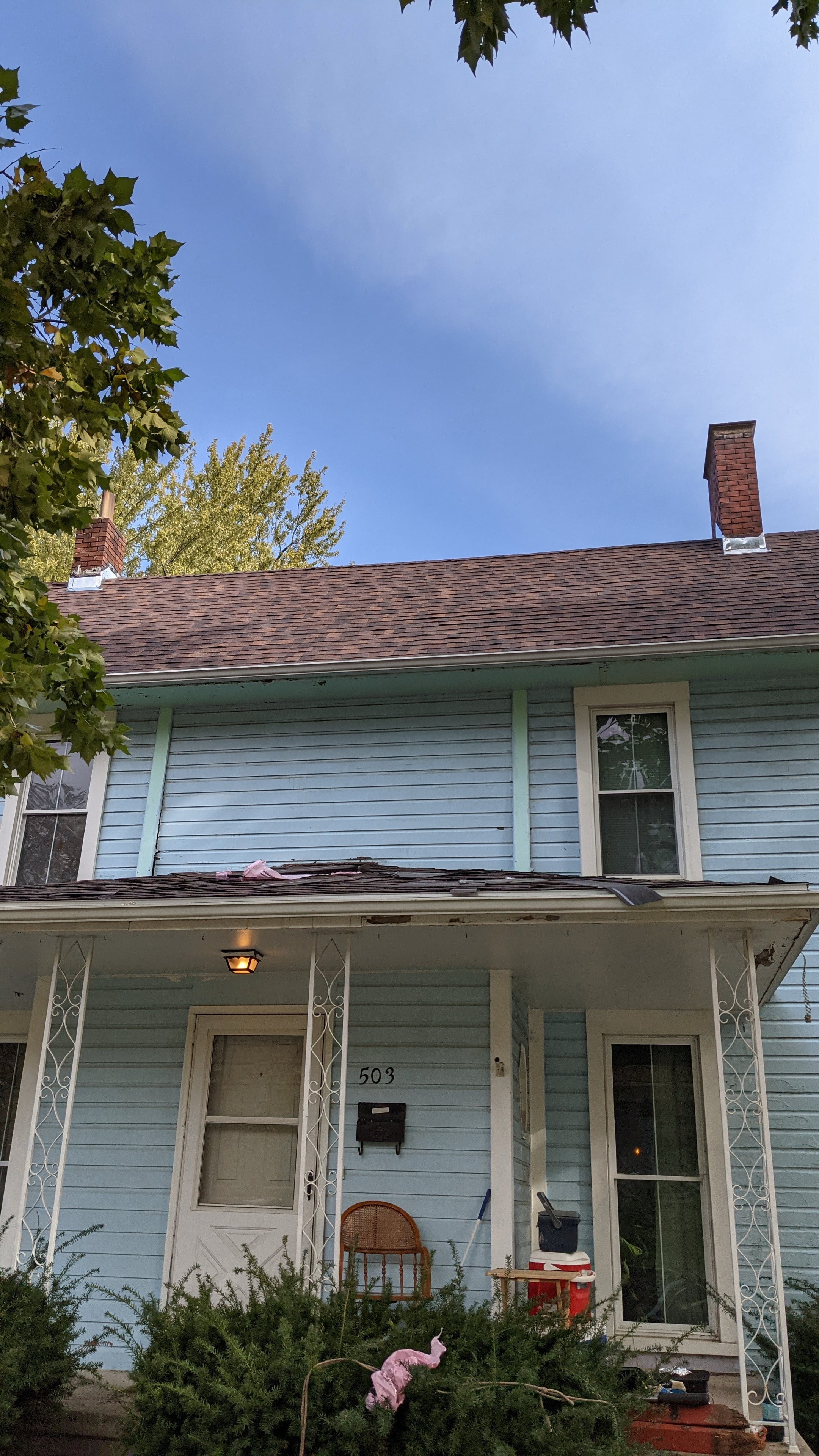 Completed roof — light blue two-story home