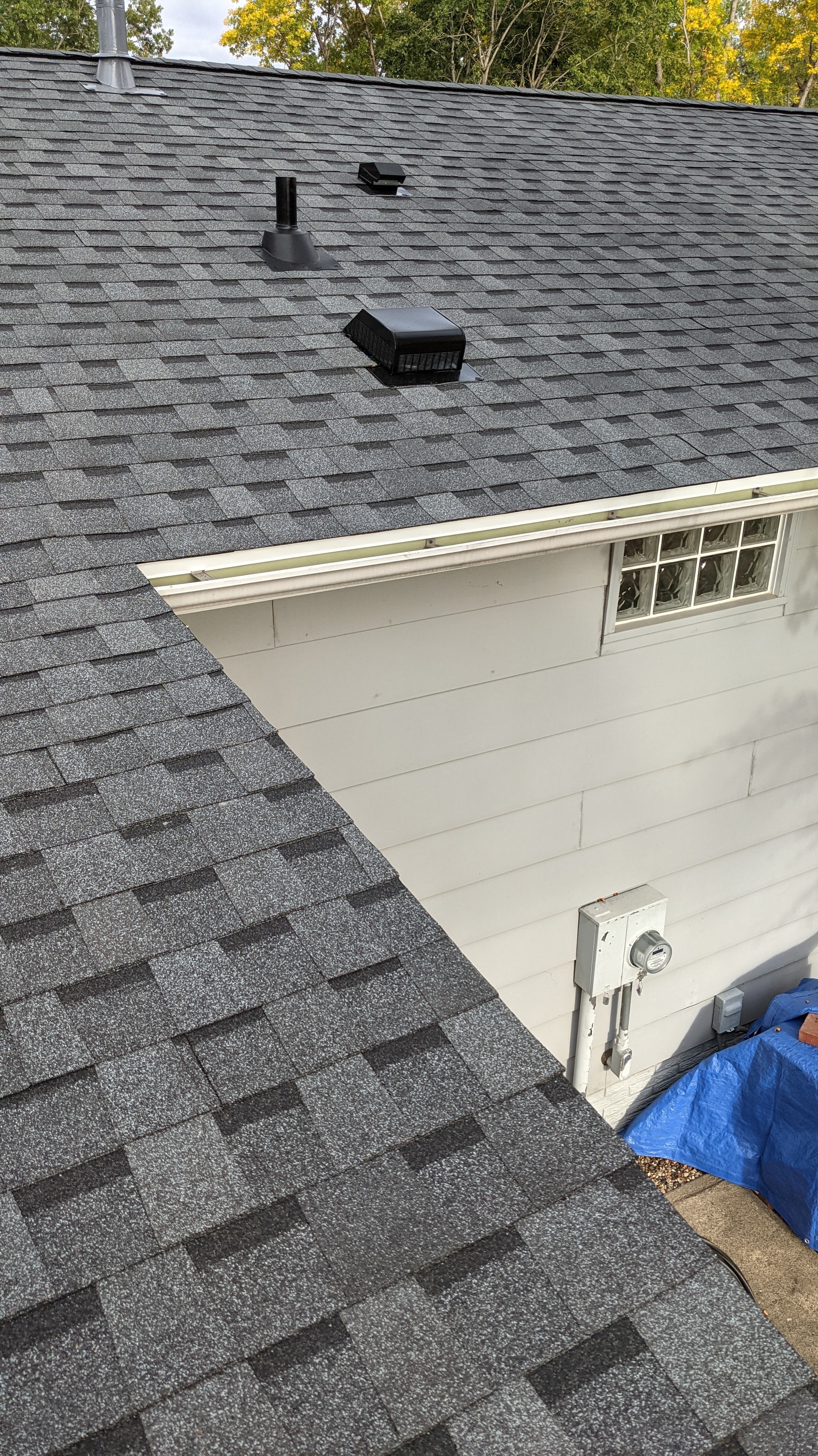 Completed roof with new gutters and siding