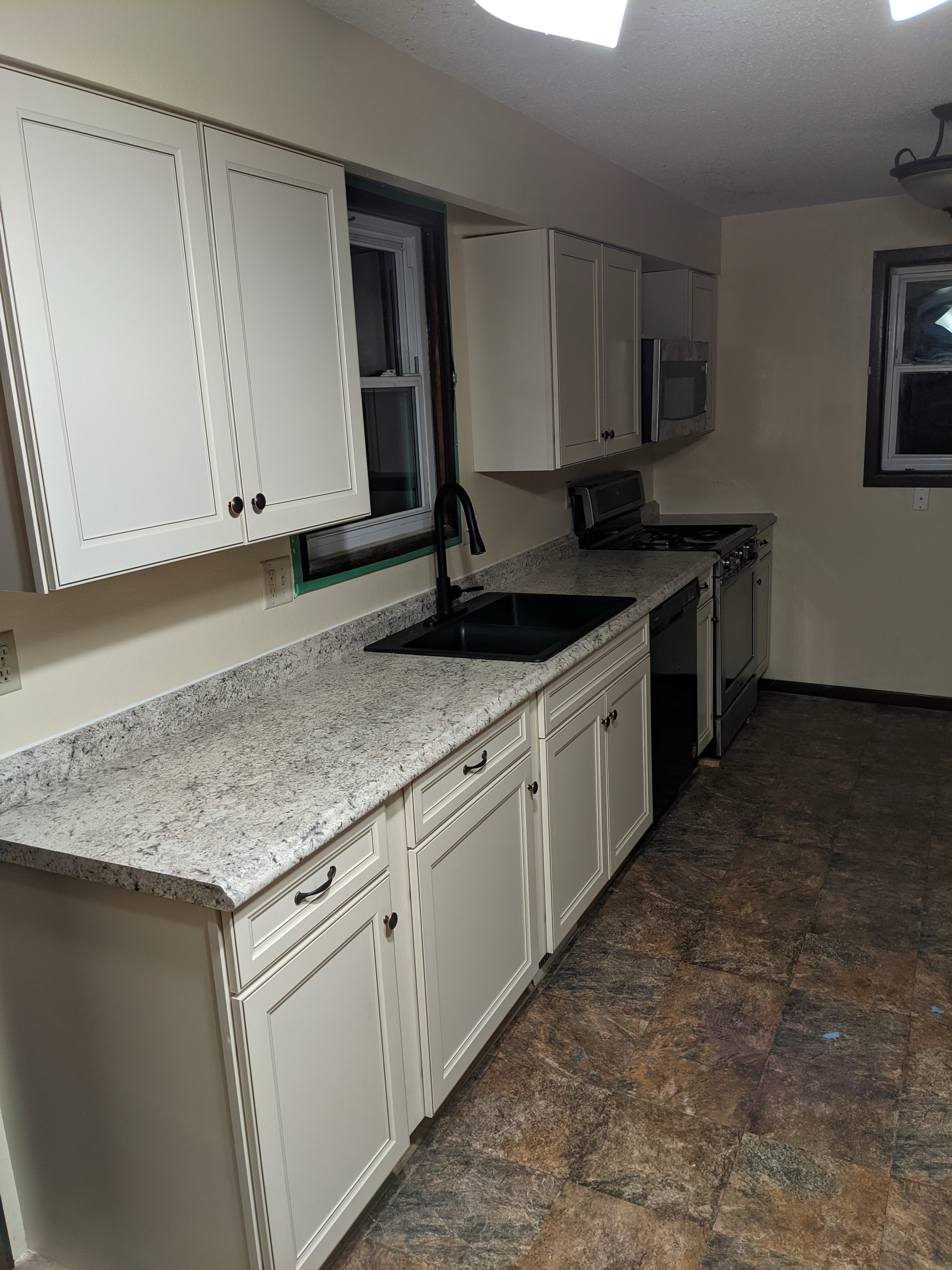 Kitchen remodel — full view with new cabinets and granite counters