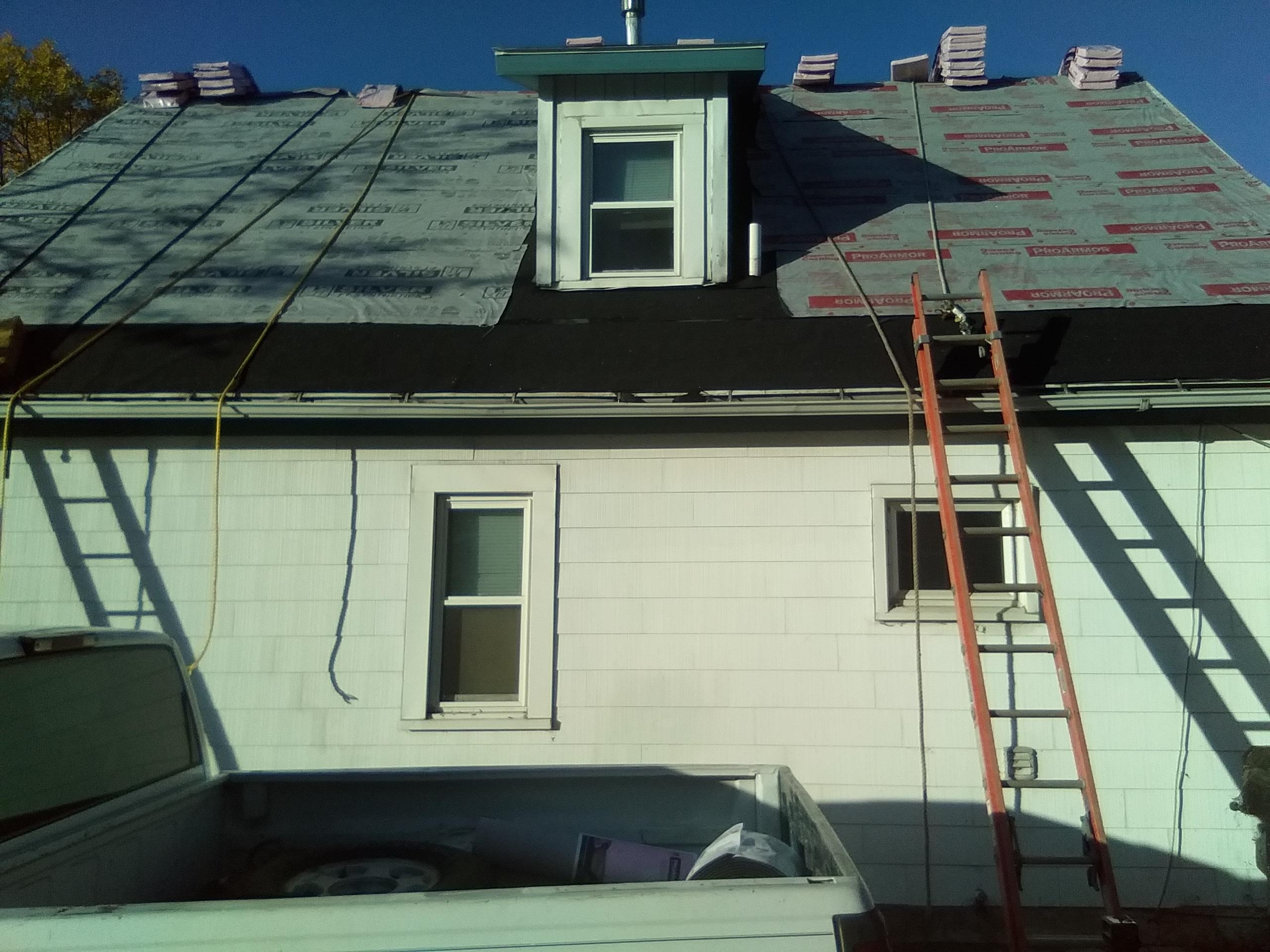 Roof underlayment staged — shingles ready to install