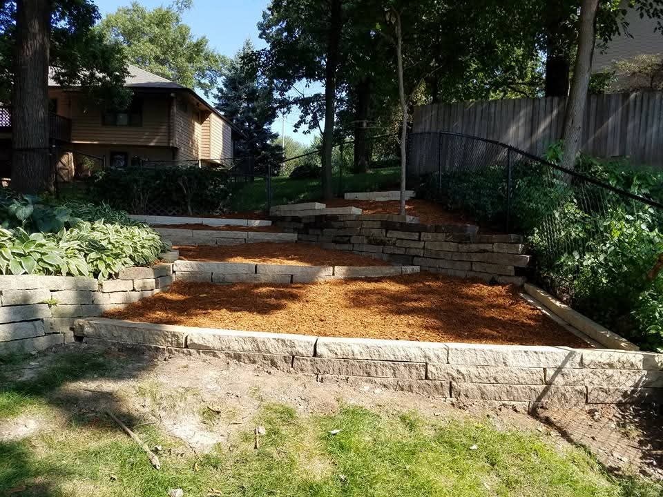 Tiered stone retaining walls with fresh mulch