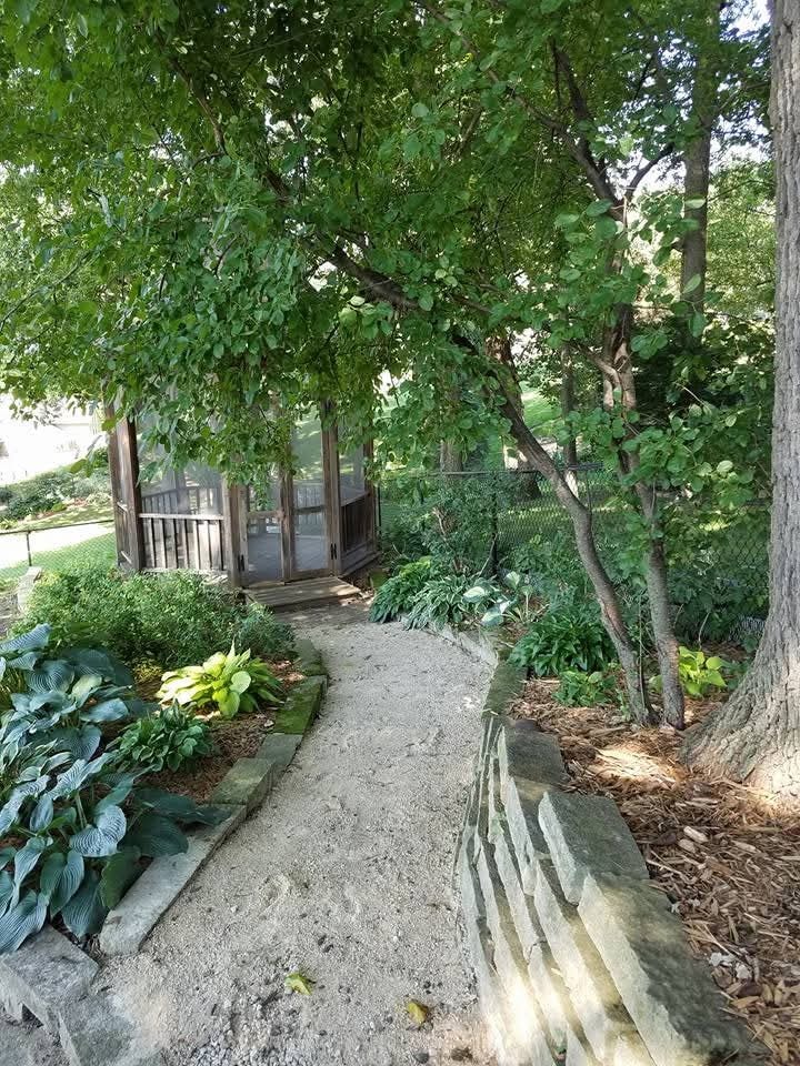 Stone garden pathway leading to screened porch