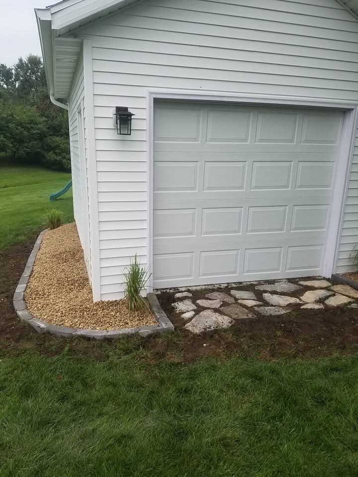 Garage exterior — gravel bed with stone step edging