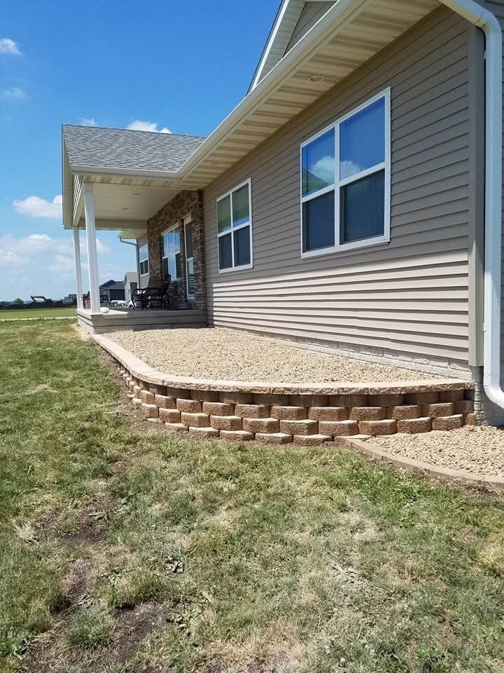 Curved retaining wall with gravel bed — full front view