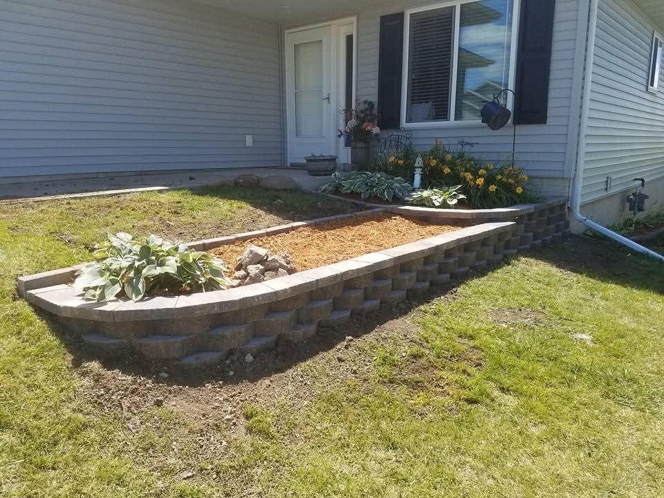 Block retaining wall and raised planter bed — front entry
