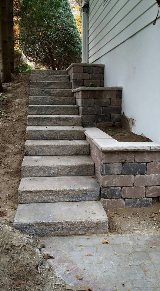 Block retaining wall steps — multi-level stone staircase with planter walls
